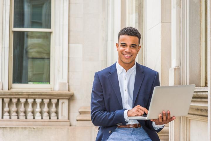 a man holding laptop on his hands